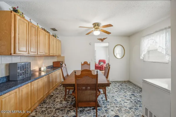 a view of a dining room and kitchen with a table chairs and a chandelier