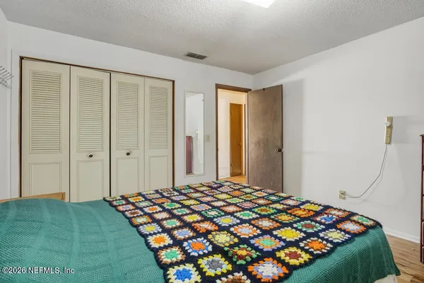 a bedroom with a bed and a closet