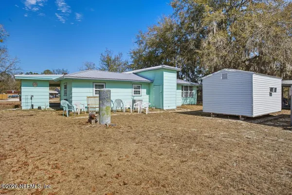 a view of a house with a yard and garage