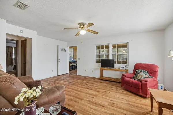 a bedroom with furniture and a window