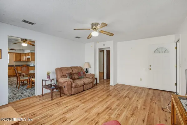 a living room with furniture and wooden floor
