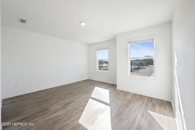 a bathroom with a granite countertop sink a toilet and a mirror
