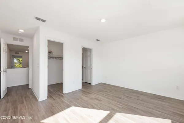 a view of an empty room and wooden floor
