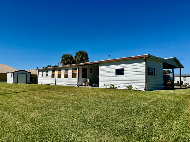 a swimming pool with outdoor seating and yard