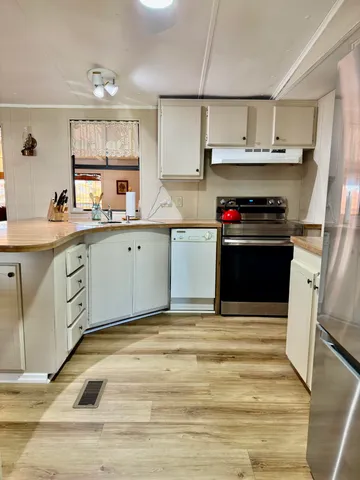 walk in closet with a large mirror of a kitchen