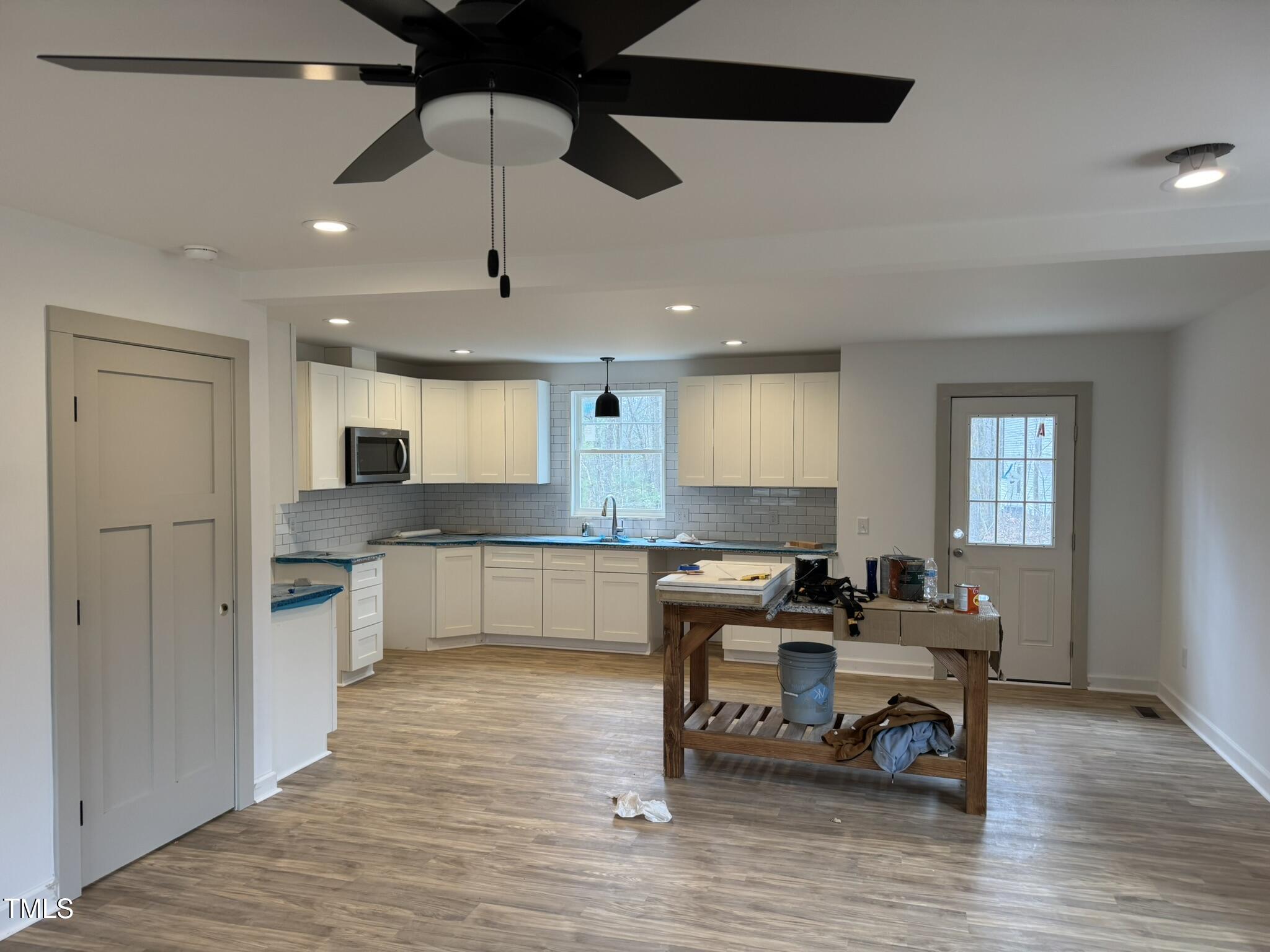 9518 Meredith Drive Rougemont, NC 27572 - Photo 4 of 12 a kitchen with stainless steel appliances kitchen island granite countertop a stove a sink a dining table and chairs with wooden floor