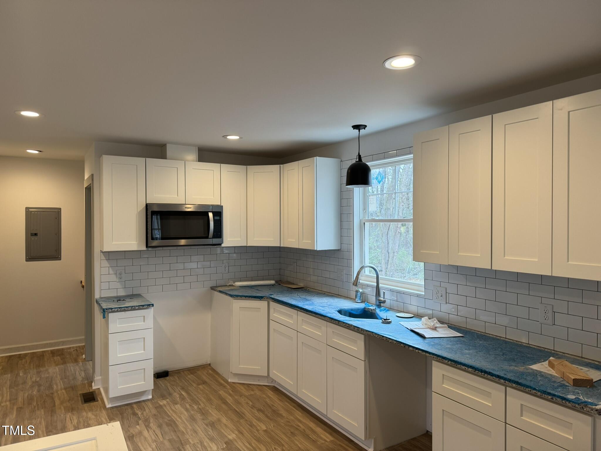 9518 Meredith Drive Rougemont, NC 27572 - Photo 5 of 12 a kitchen with kitchen island granite countertop a sink stainless steel appliances and cabinets