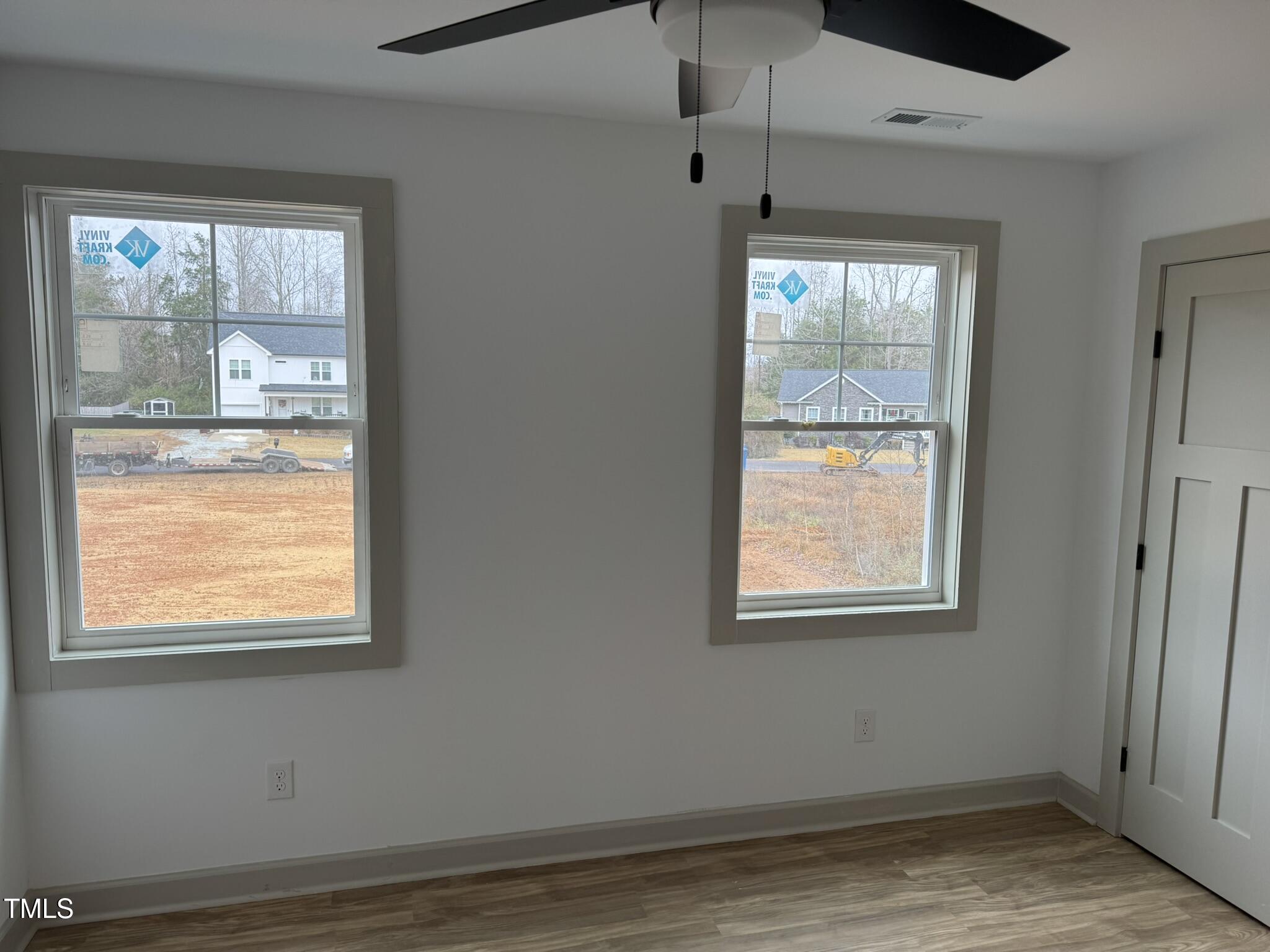 9518 Meredith Drive Rougemont, NC 27572 - Photo 7 of 12 an empty room with wooden floor and windows