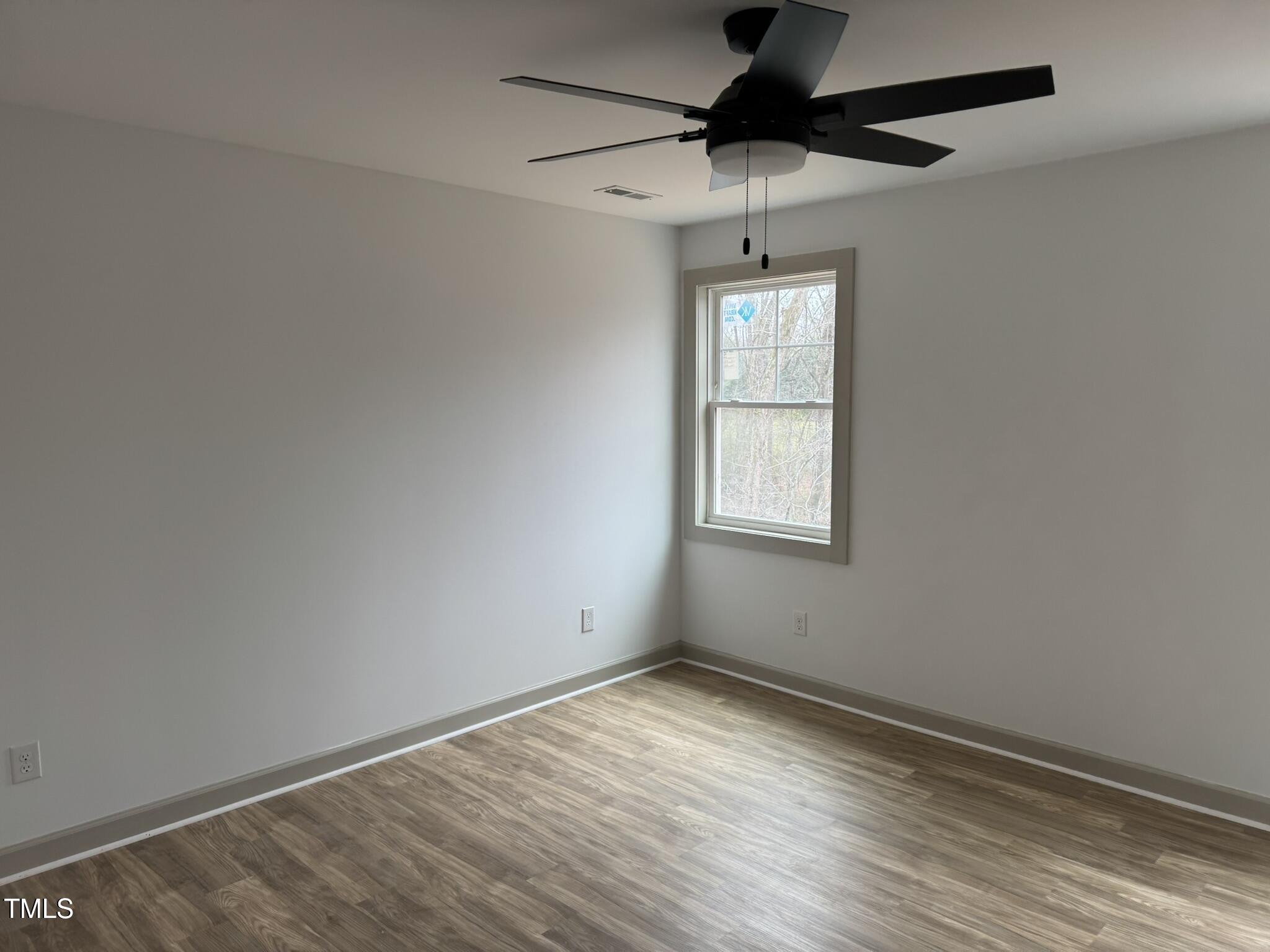 9518 Meredith Drive Rougemont, NC 27572 - Photo 8 of 12 an empty room with a window and a ceiling fan