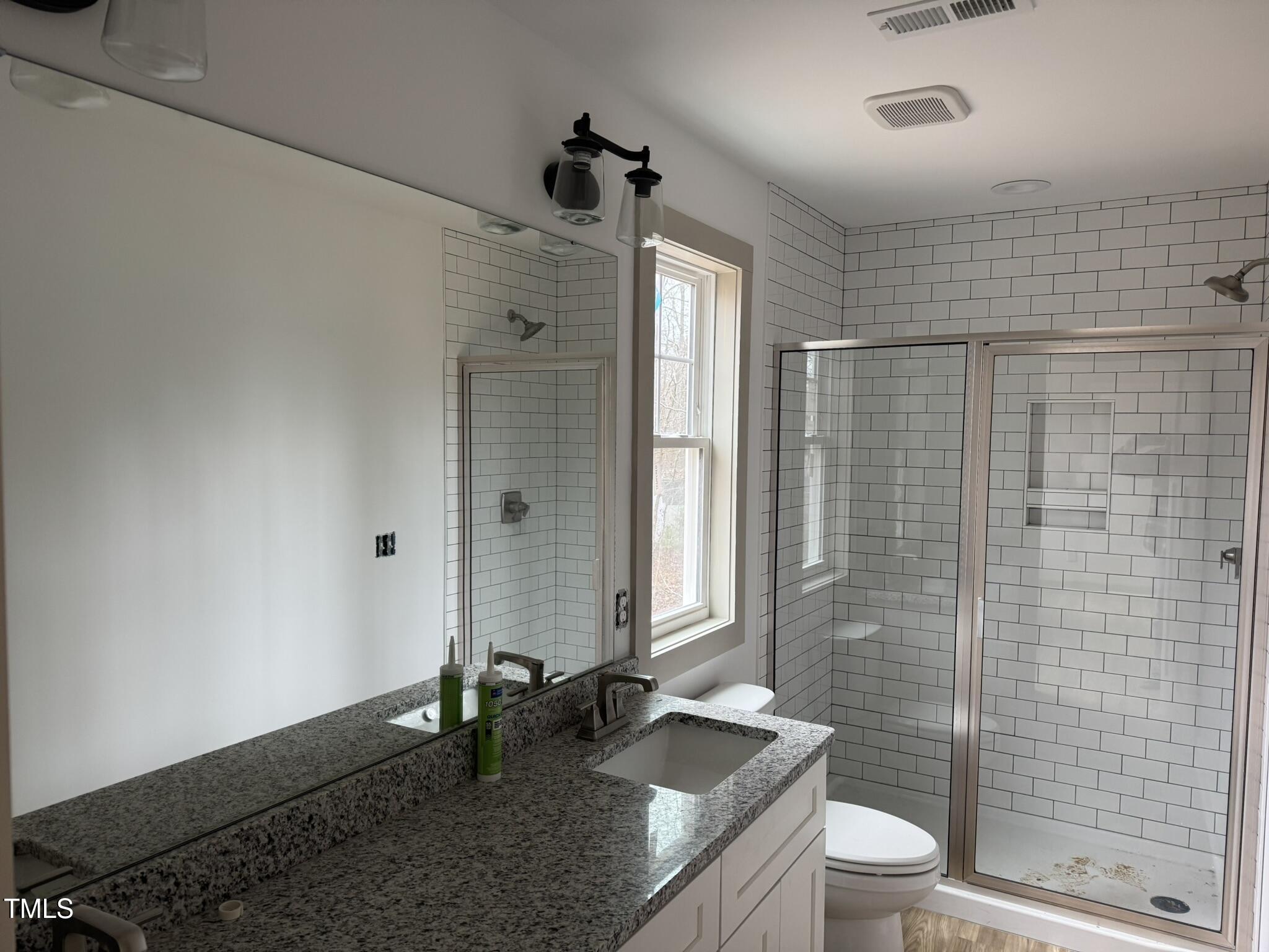 9518 Meredith Drive Rougemont, NC 27572 - Photo 9 of 12 a bathroom with a granite countertop sink a toilet and shower