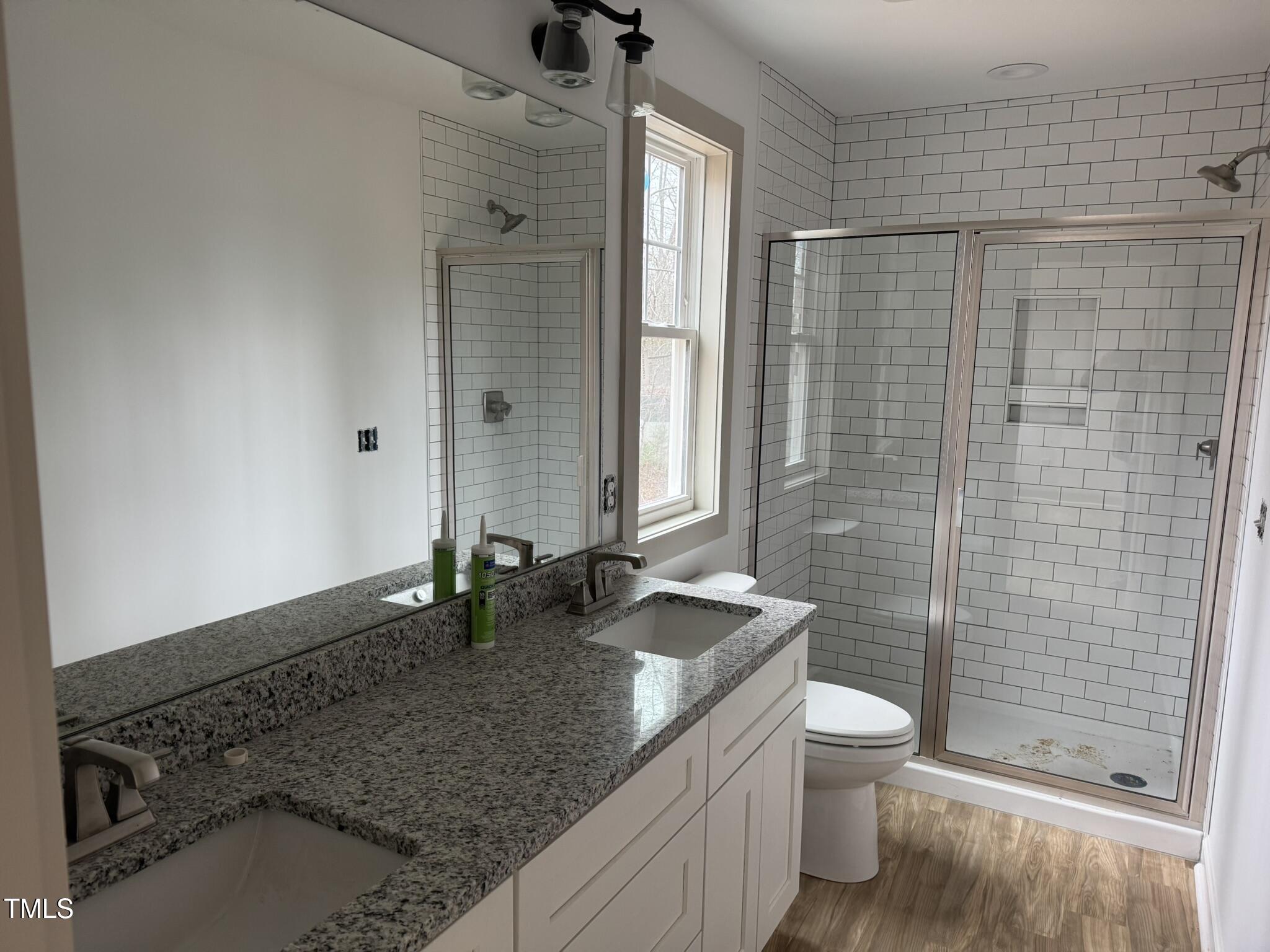 9518 Meredith Drive Rougemont, NC 27572 - Photo 10 of 12 a bathroom with a granite countertop sink a toilet and shower