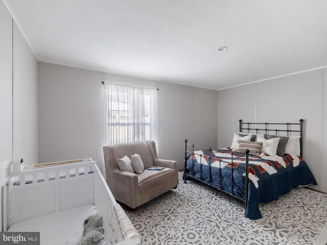 a bedroom with a bed and a mirror