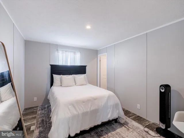 a bedroom with a bed and a chair