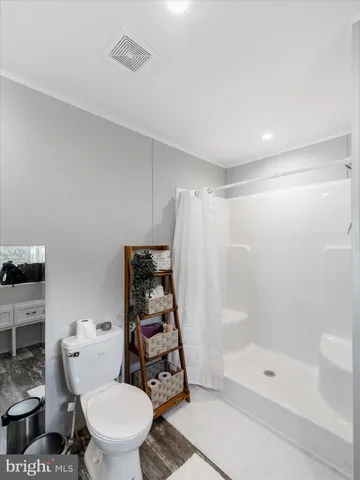 a walk in closet with clothes and shoes