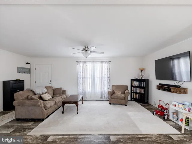 a living room with furniture and kitchen view
