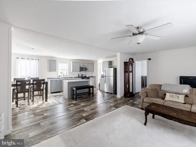 a view of kitchen with sink microwave and dining table