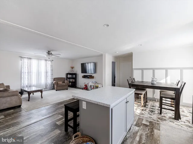a kitchen with appliances and chairs in it