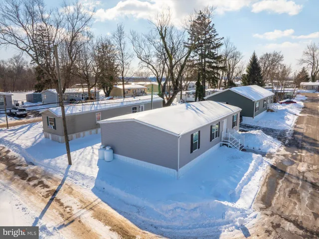 a white house with a yard and sitting area