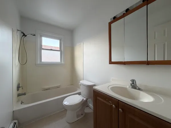 a bathroom with a sink toilet vanity and shower