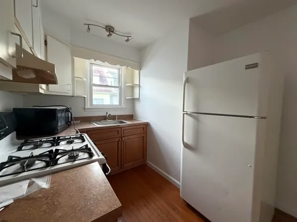 a kitchen with stainless steel appliances a stove a refrigerator and a sink