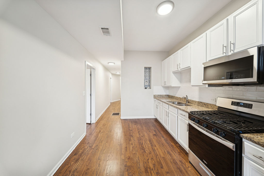 6520 South Ellis Avenue Chicago, IL 60637 - Photo 11 of 38 a large kitchen with a stove and a sink