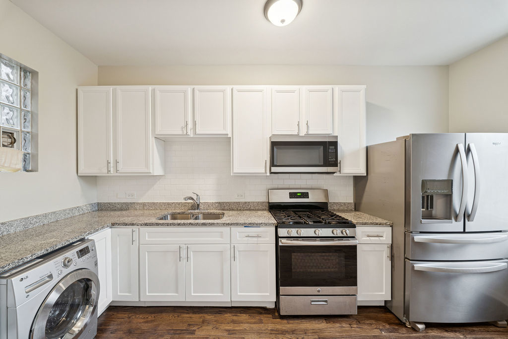 6520 South Ellis Avenue Chicago, IL 60637 - Photo 20 of 38 a kitchen with stainless steel appliances a stove a sink and a refrigerator
