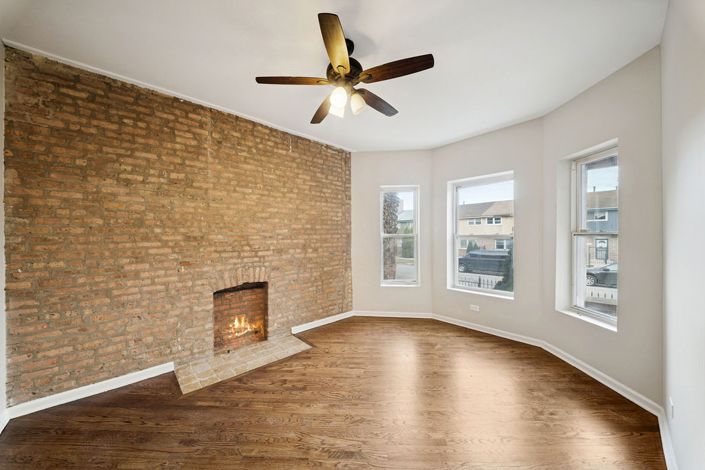 6520 South Ellis Avenue Chicago, IL 60637 - Photo 2 of 38 a view of empty room with wooden floor and fan