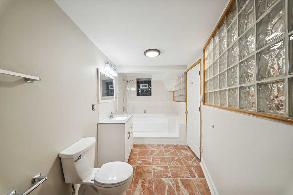 6520 South Ellis Avenue Chicago, IL 60637 - Photo 27 of 38 a white toilet sitting next to a bathroom sink