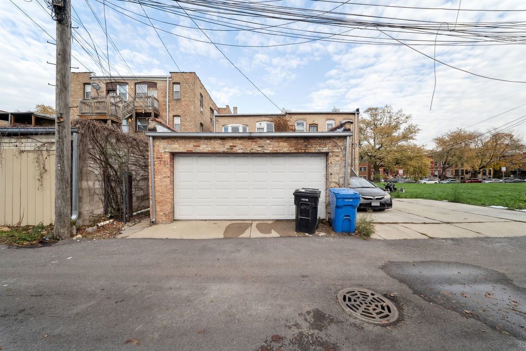 6520 South Ellis Avenue Chicago, IL 60637 - Photo 36 of 38 a view of a house with large space and a car parked on road