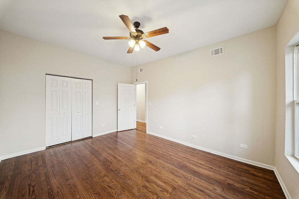 6520 South Ellis Avenue Chicago, IL 60637 - Photo 5 of 38 a view of an empty room with wooden floor