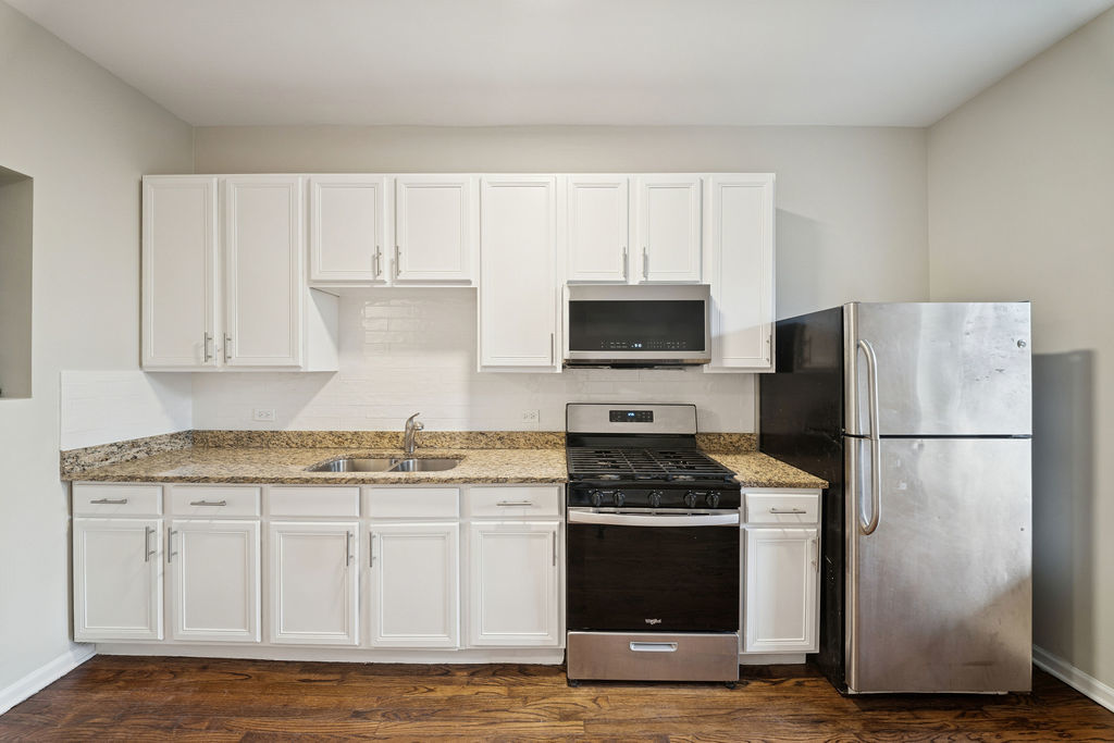 6520 South Ellis Avenue Chicago, IL 60637 - Photo 10 of 38 a kitchen with granite countertop white cabinets and refrigerator