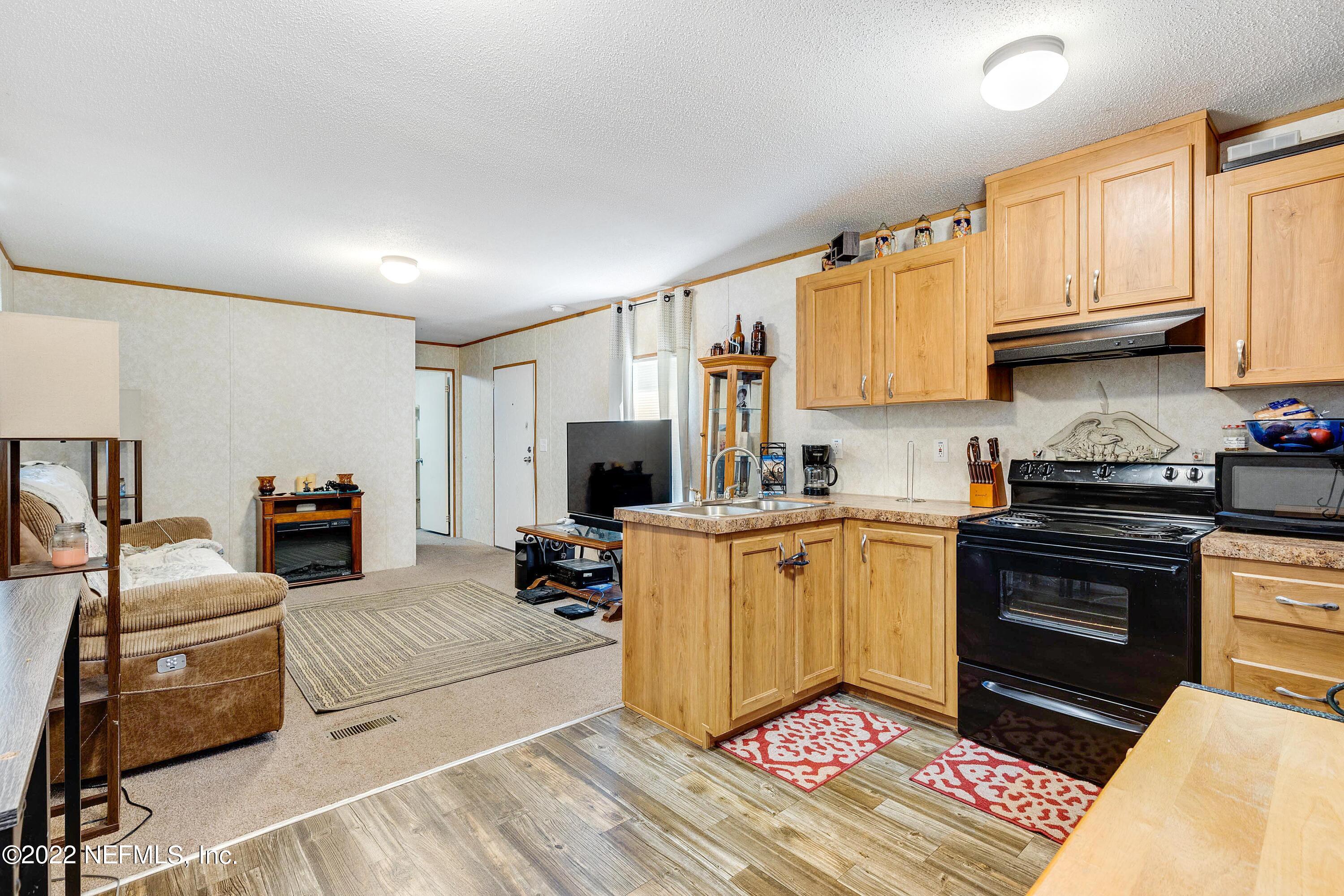 1450 Jones Road Jacksonville, FL 32220 - Photo 27 of 42 Kitchen and Living Area Mobile Home