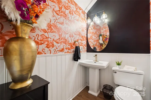 a bathroom with a sink mirror and toilet