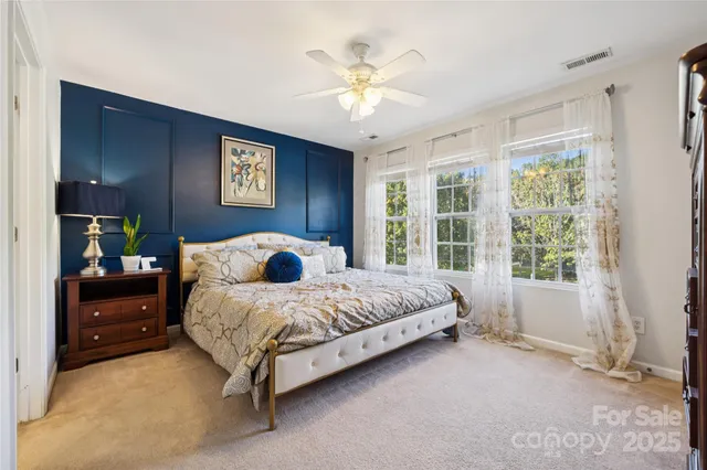 a spacious bedroom with a bed and a window