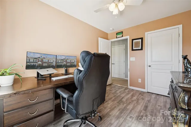 a view of a workspace with furniture and a lamp