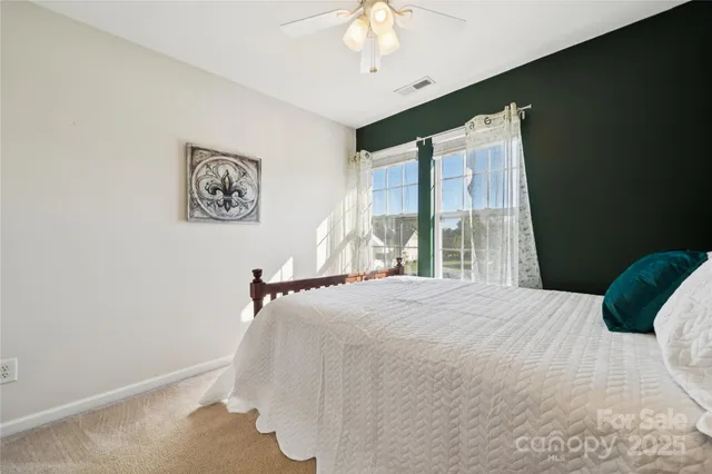 a bedroom with a bed and a large window