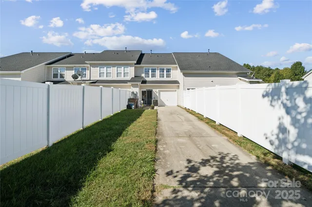 a view of a swimming pool with an outdoor seating and a yard