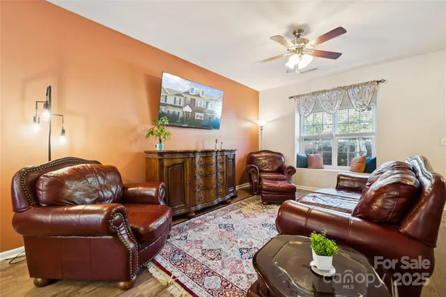 a living room with furniture a rug and a window