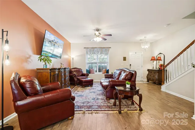 a living room with furniture and wooden floor