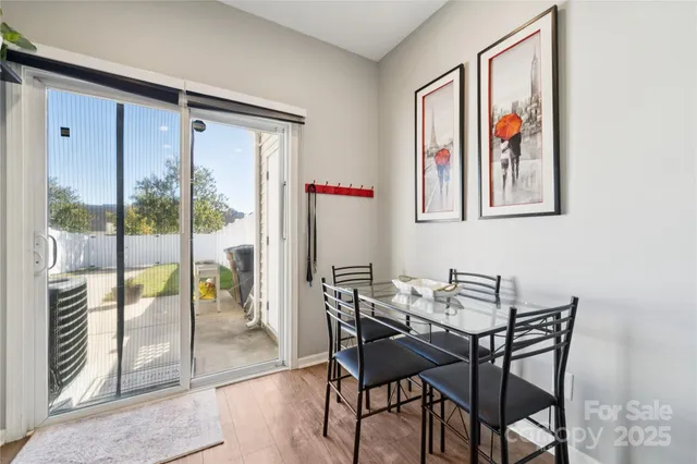 a view of a dining room with furniture a chandelier and wooden floor