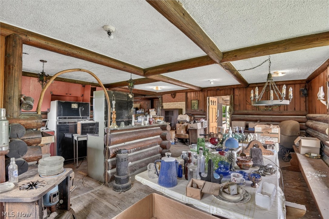 1526 Stevenson Road Ashtabula, OH 44004 - Photo 36 of 50 Interior space with exposed wood beam ceiling, wood plank walls, and a log cabin-style bar