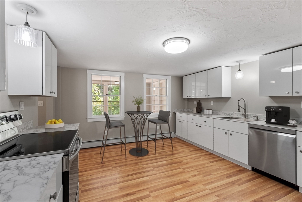 34 Morse Road Royalston, MA 01368 - Photo 2 of 42 a kitchen with a stove a sink a dining table and chairs