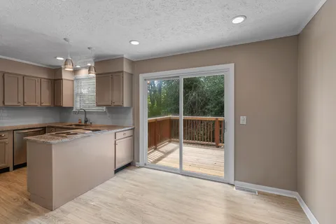 a kitchen with stainless steel appliances granite countertop a stove and a sink