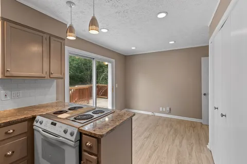 a stove top oven sitting inside of a kitchen