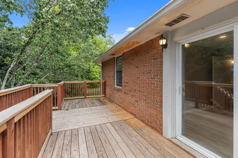 a view of balcony with wooden floor and outer view