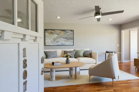 a living room with furniture and wooden floor