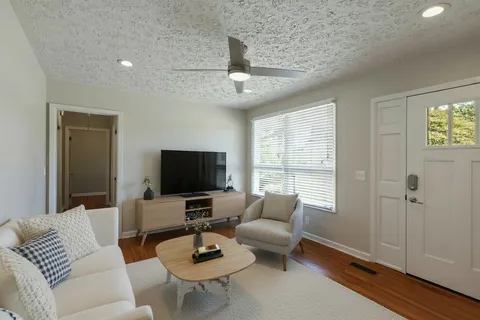 a living room with furniture and a flat screen tv