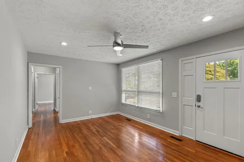 wooden floor in an empty room with a window