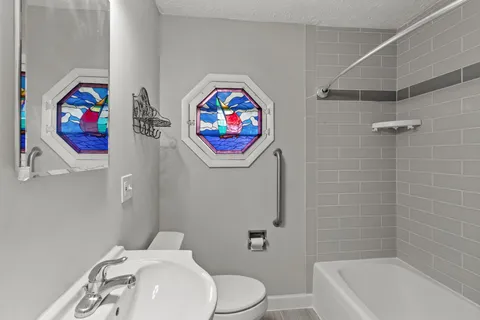 a bathroom with a toilet a sink and a bathtub