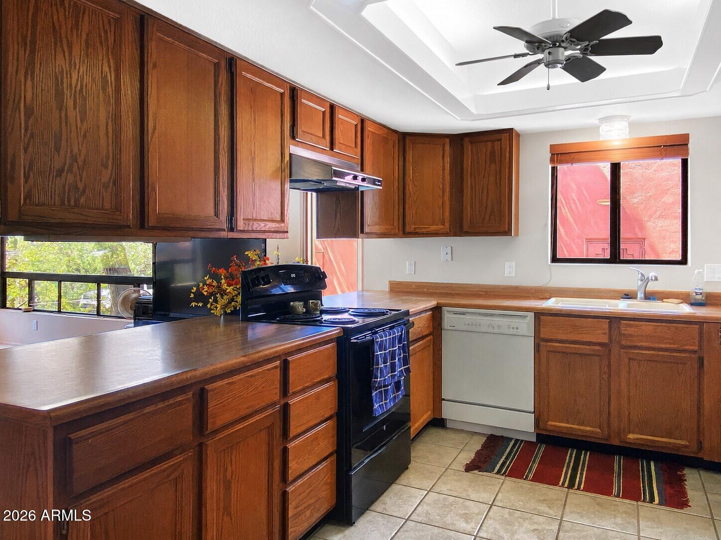 550 Barcelona Road Sedona, AZ 86336 - Photo 12 of 32 a kitchen with granite countertop a sink stainless steel appliances and cabinets